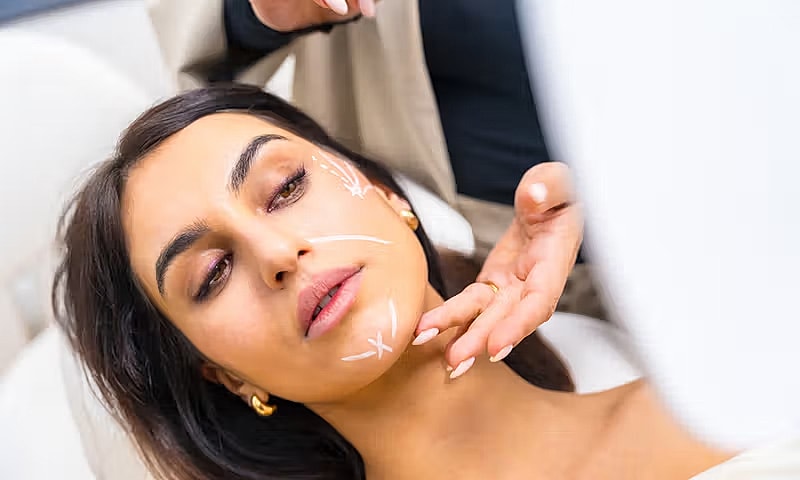 Woman receiving skincare treatment in salon.