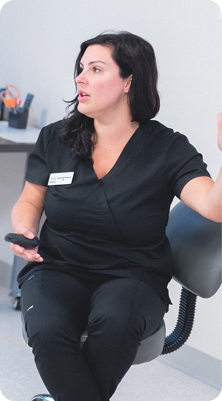 Medical professional in casual work attire speaking.