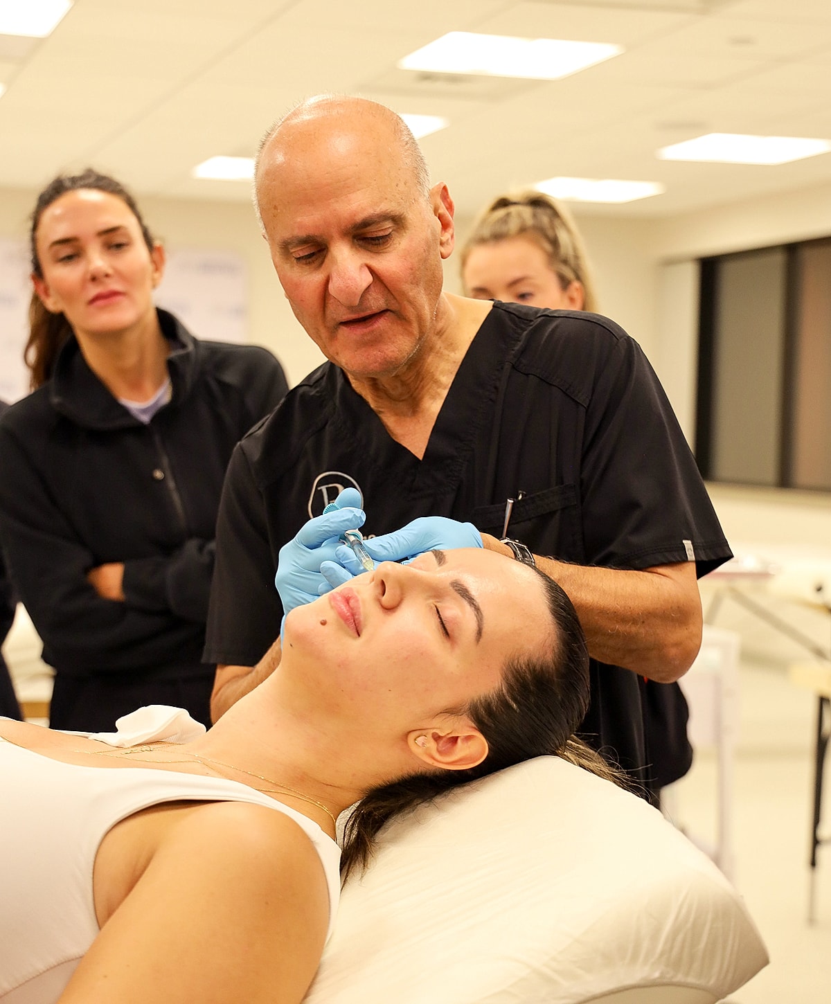 Dermatologist administering treatment to a patient.