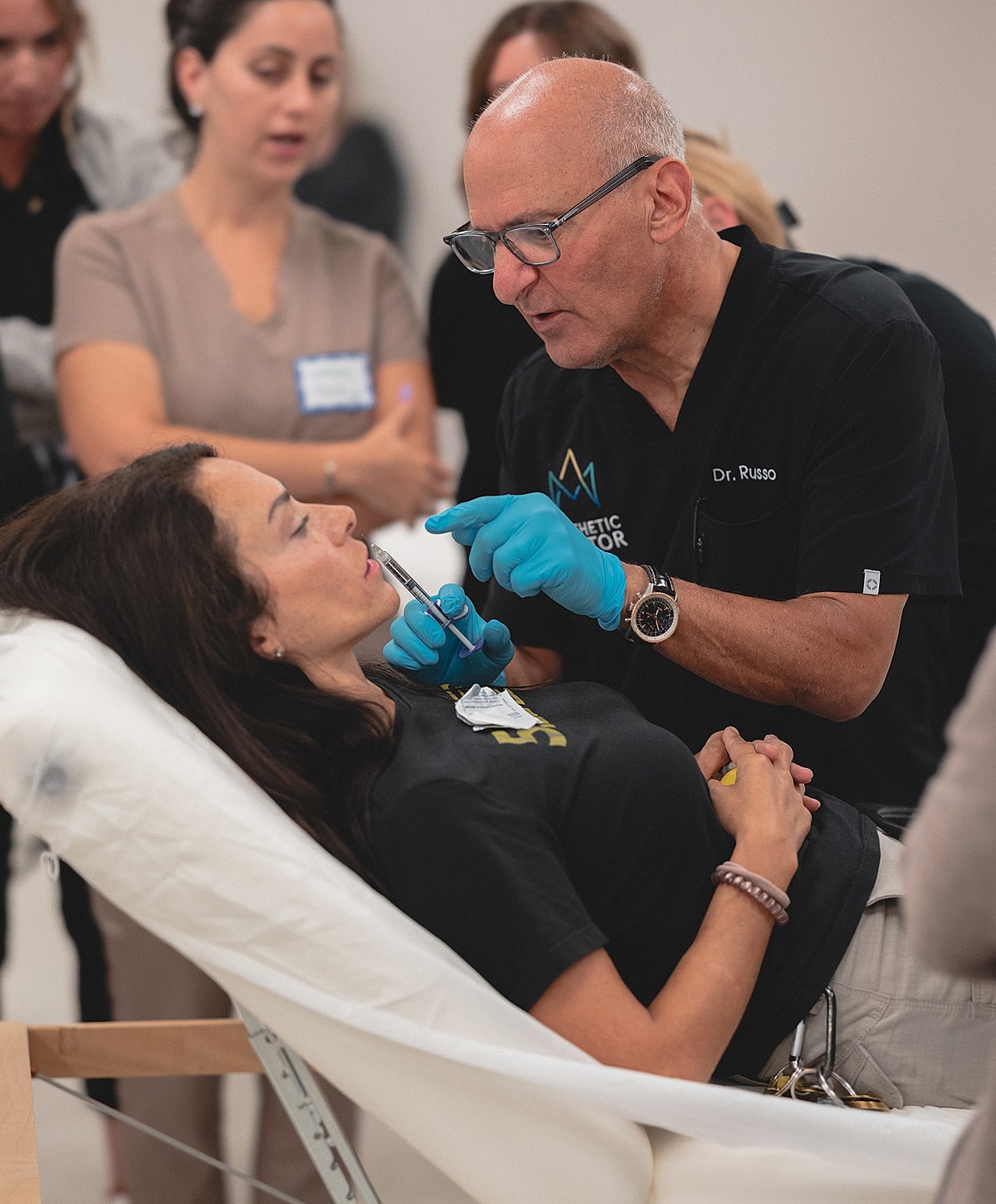Dr. Russo demonstrating aesthetic treatment techniques.