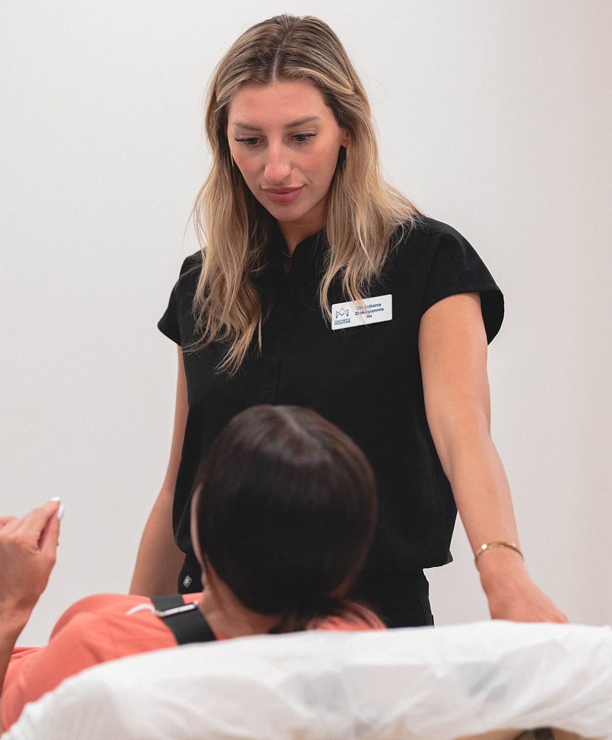 Practitioner administering lip filler treatment session.
