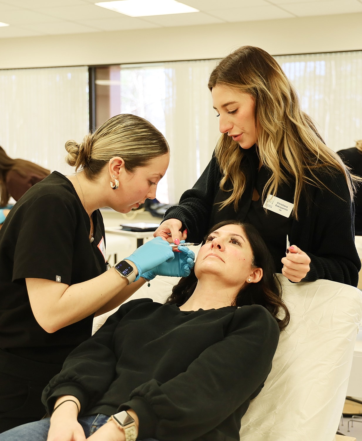 Practicing cosmetic procedure on client during training.