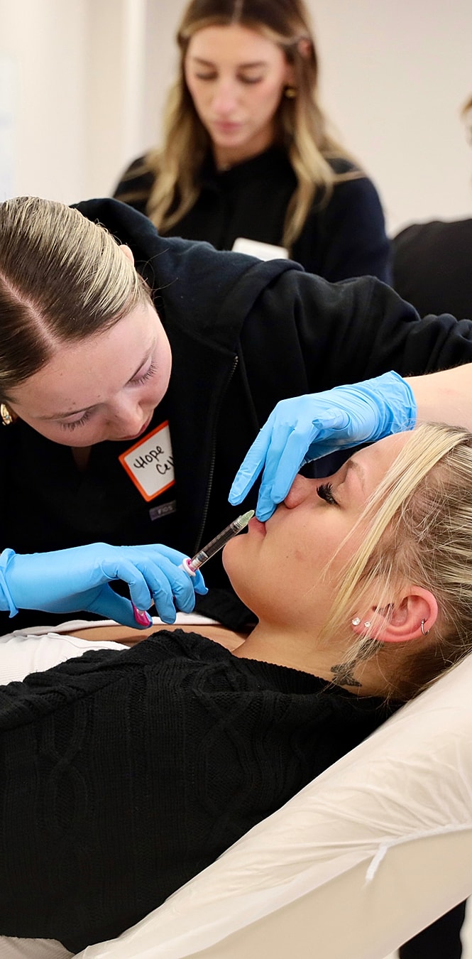 Two professionals performing a cosmetic procedure.