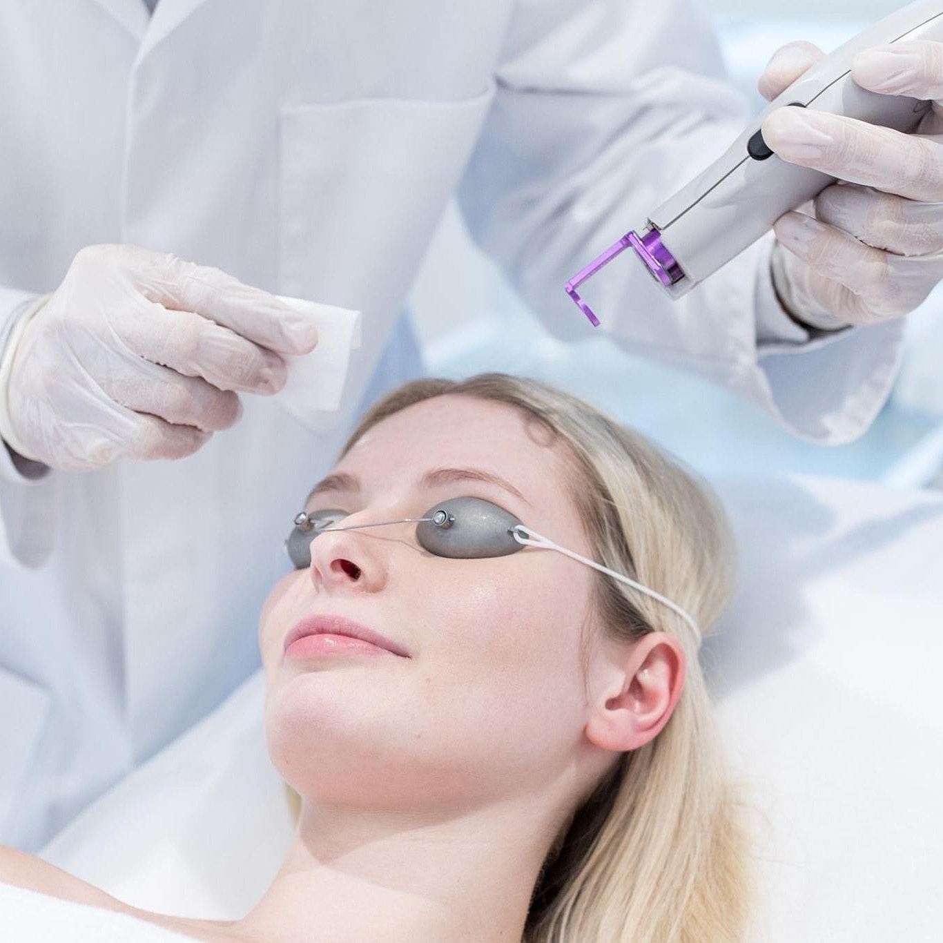Woman receiving a facial treatment in clinic.