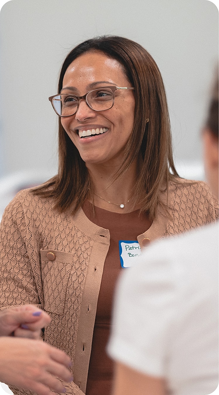 Smiling woman at a casual gathering.