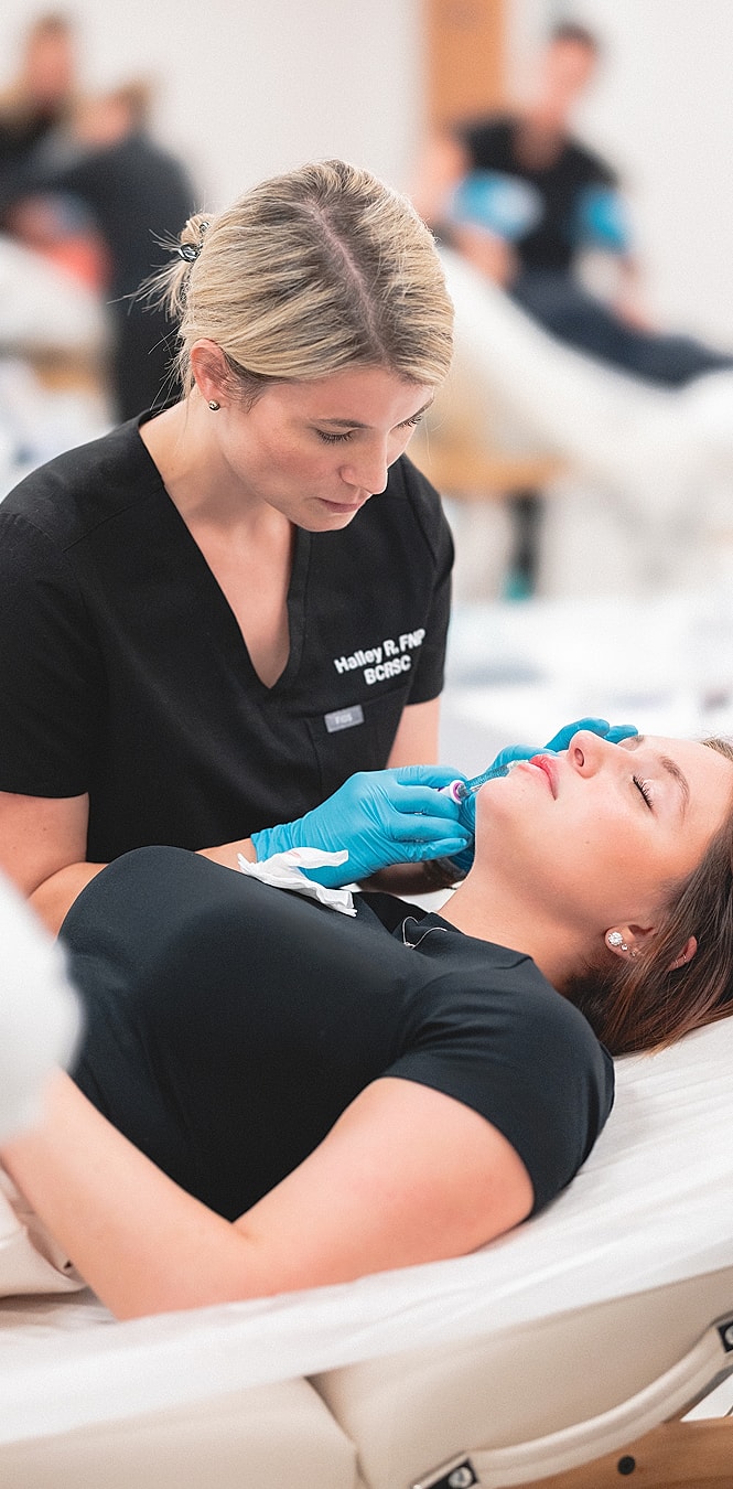 Practicing cosmetic procedure on client during training.