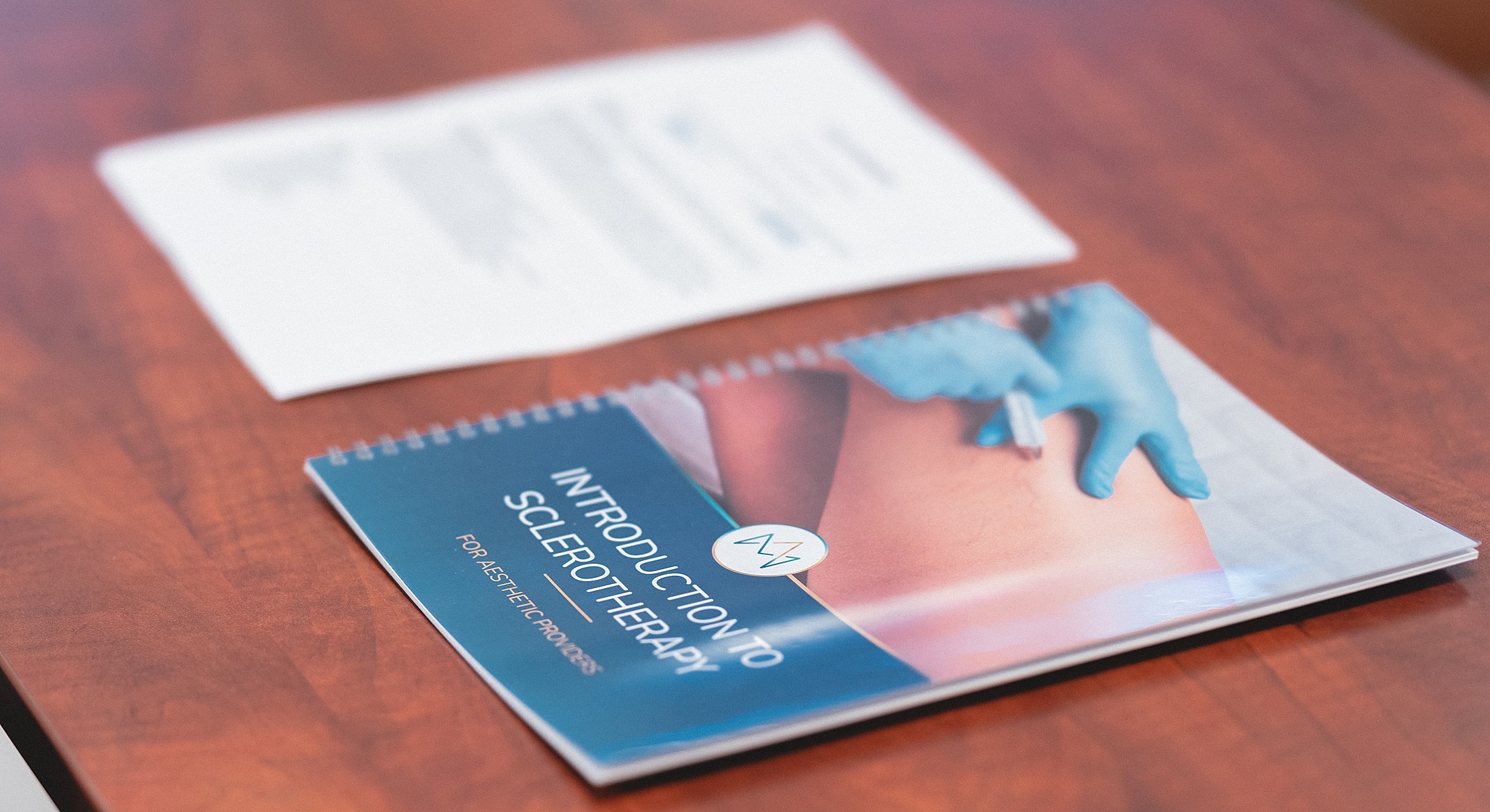 Introduction to sclerotherapy brochure on a table.