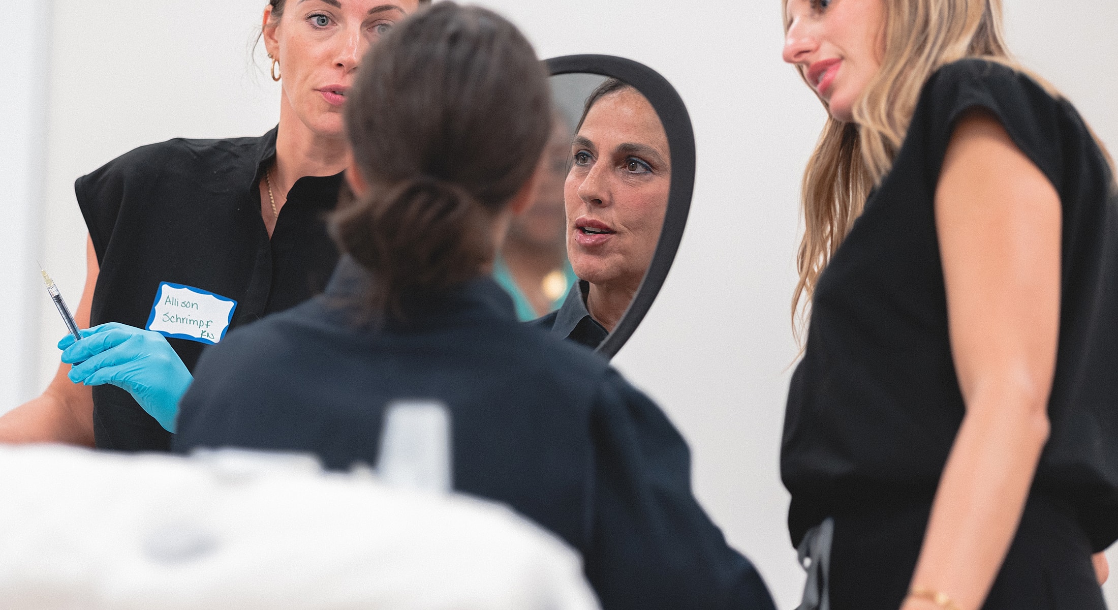 Women discussing cosmetic procedures in a clinic.