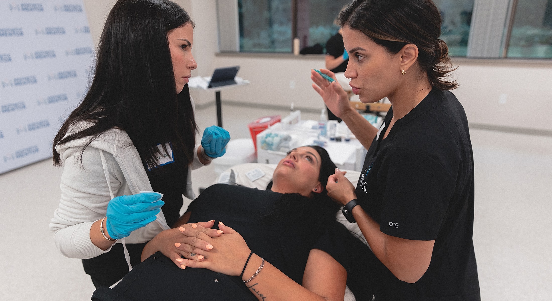 Medical professionals discussing a procedure with patient.