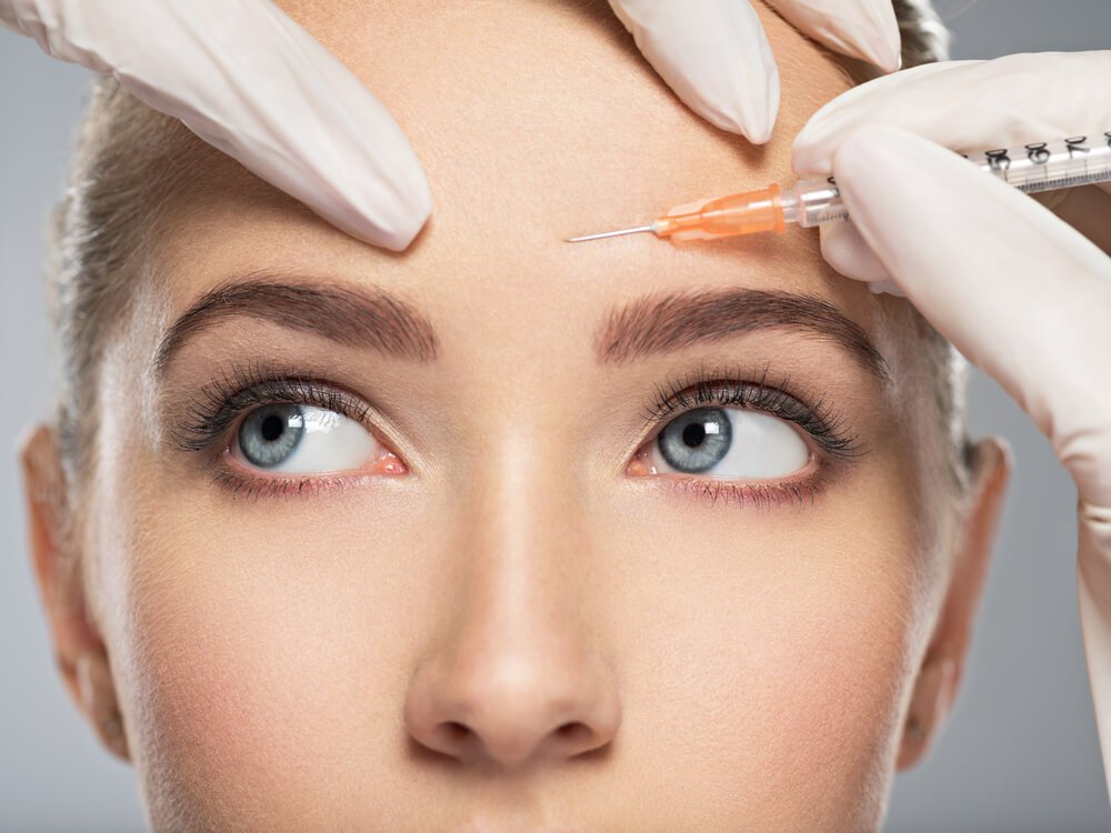 botox patient model receiving an injection in her brow