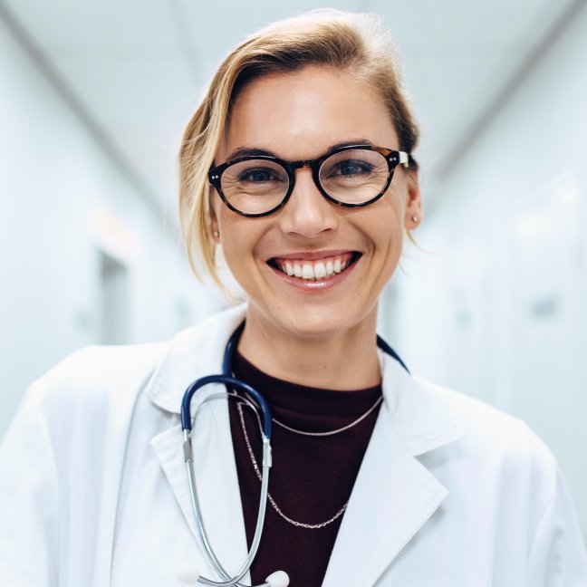 Non-Core Physicians Aesthetic Training student model in glasses smiling