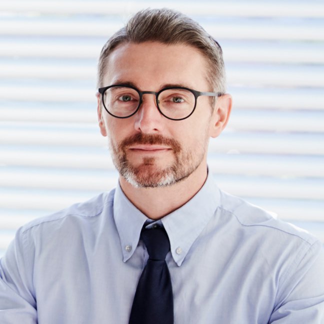 Core Physicians Aesthetic Training student model in a blue shirt and tie